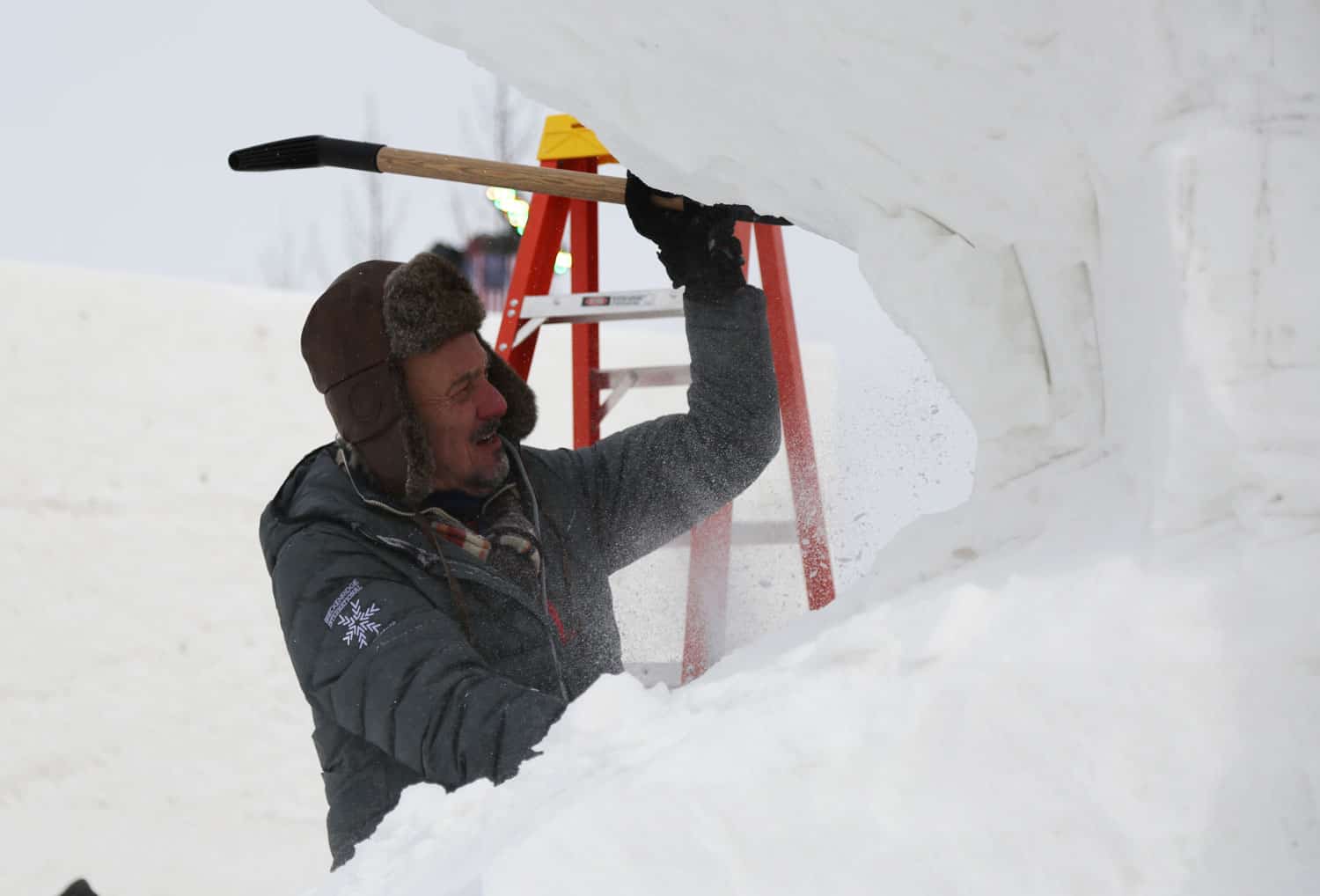 Man carving snow sculpture in Breckenridge
