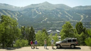 A group of people on Boreas Pass in the summer with Breckenridge Ski Resort in the Background