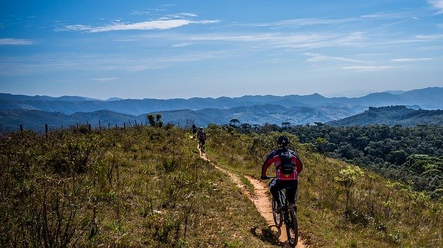 A group mountain biking with the mountains in the background
