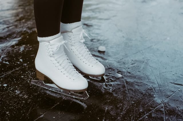 White ice skates on an ice rink