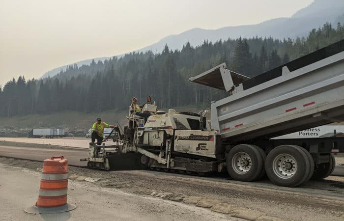 Road workers paving a highway