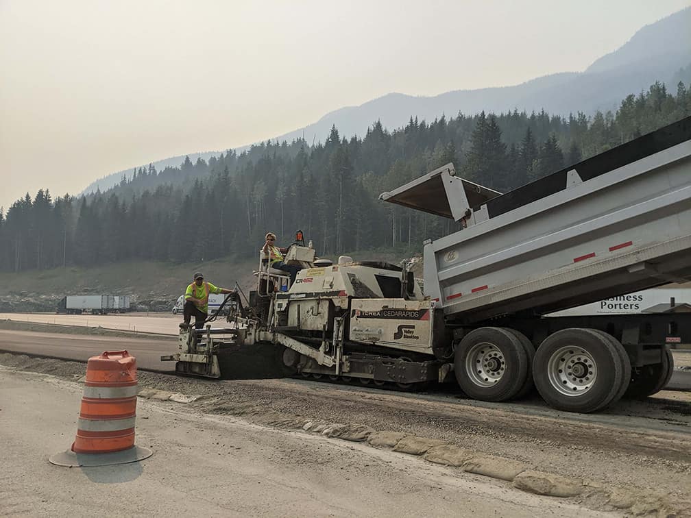 Road workers paving a highway