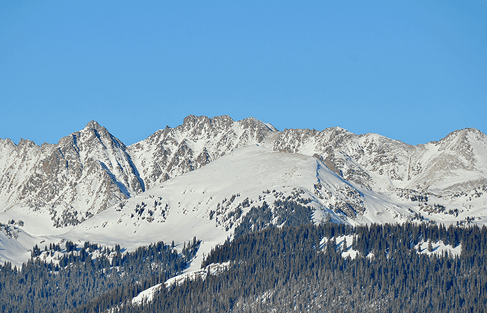 Vail ski run in the winter with a blue sky