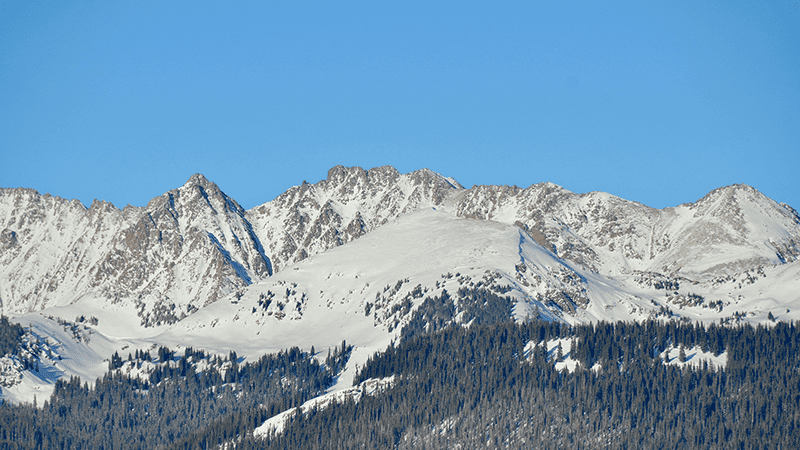 Vail ski run in the winter with a blue sky