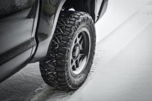 A car tire driving through the snow