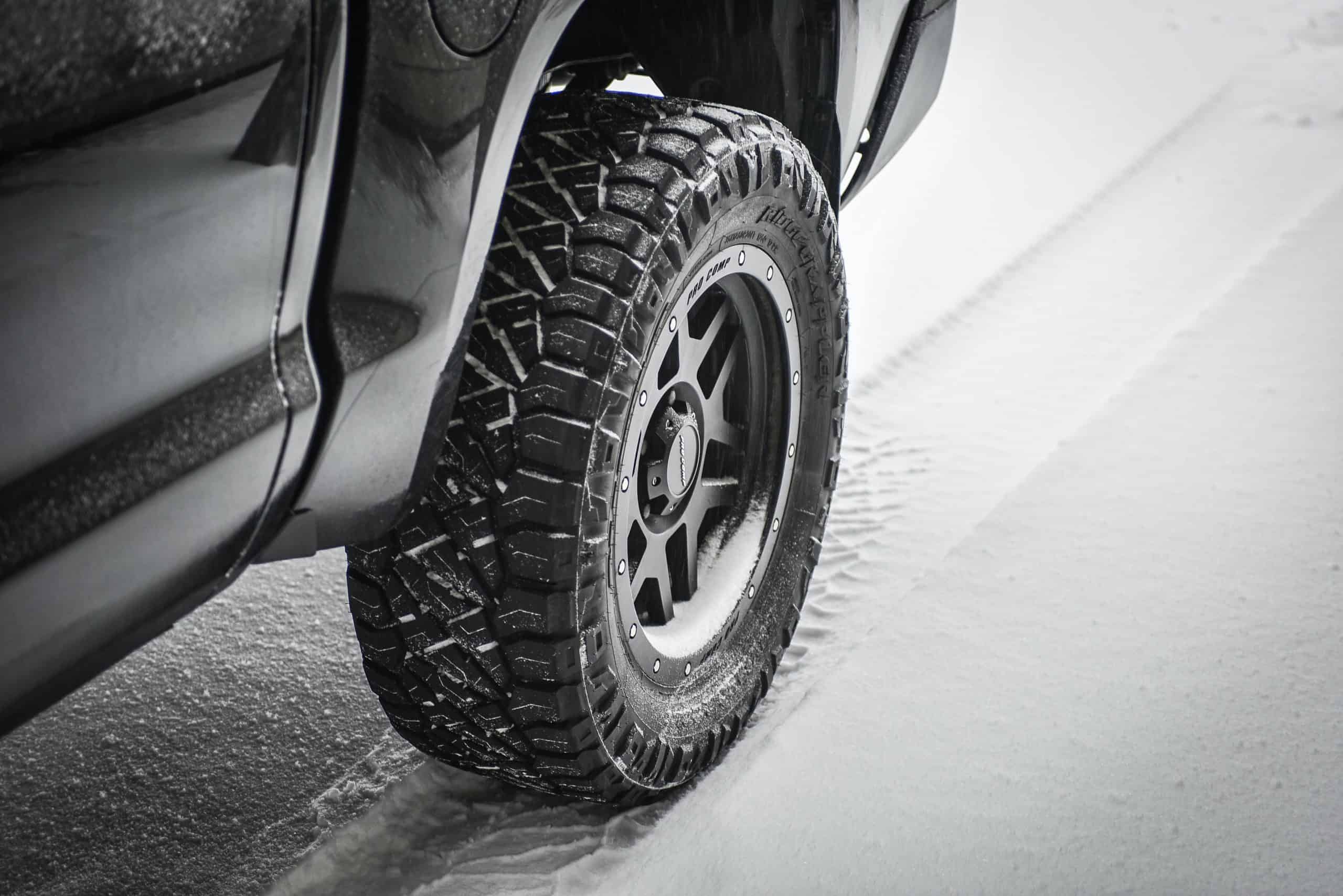 A car tire driving through the snow