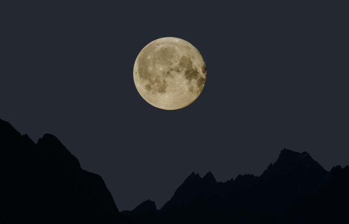 full moon with a mountain silouhette