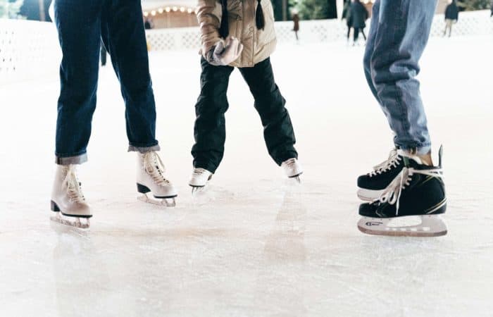 Ice skaters standing in a half circle on ice