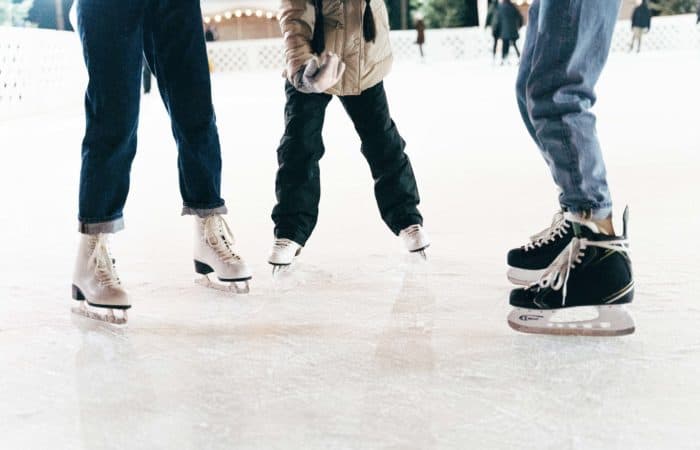 Ice skaters standing in a half circle on ice