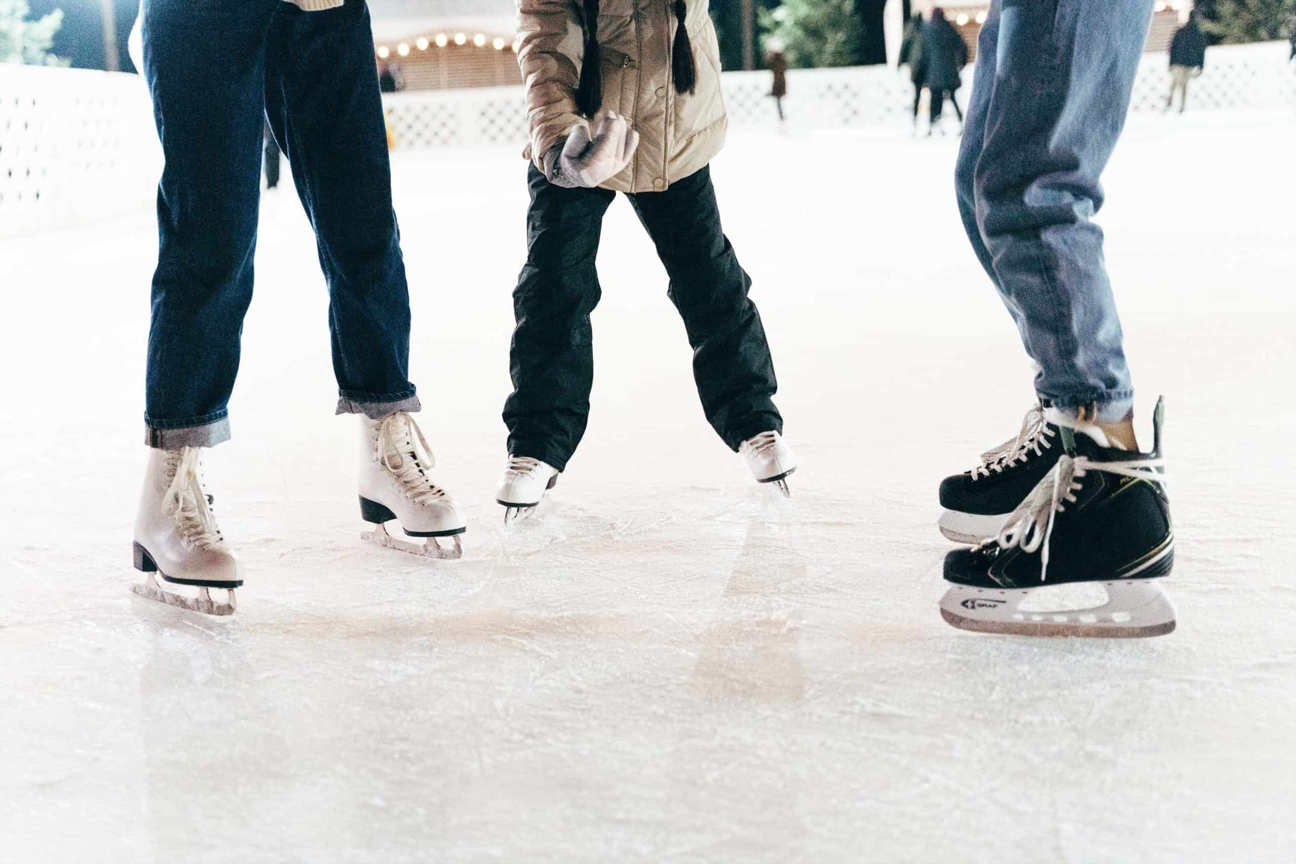 Ice skaters standing in a half circle on ice