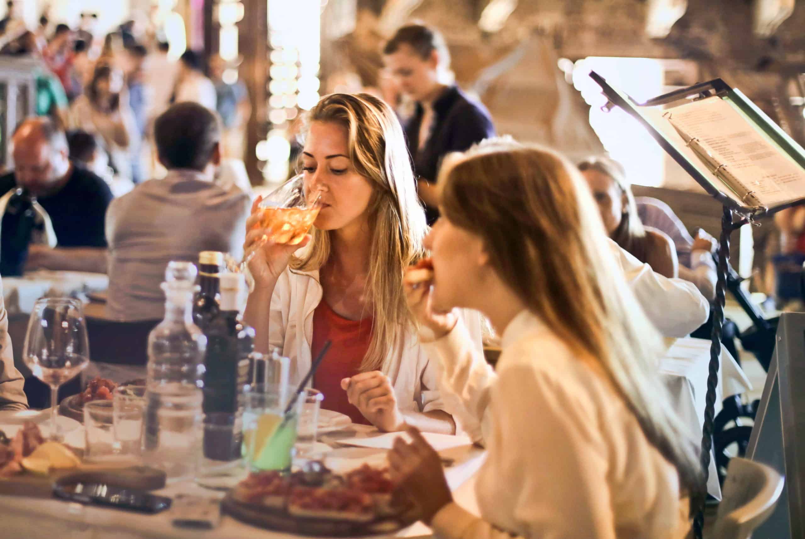 Young Woman Drinking Wine In Restaurant