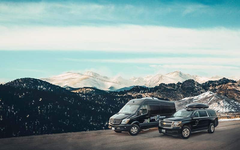 Peak 1 van and SUV with Breckenridge mountains in the background