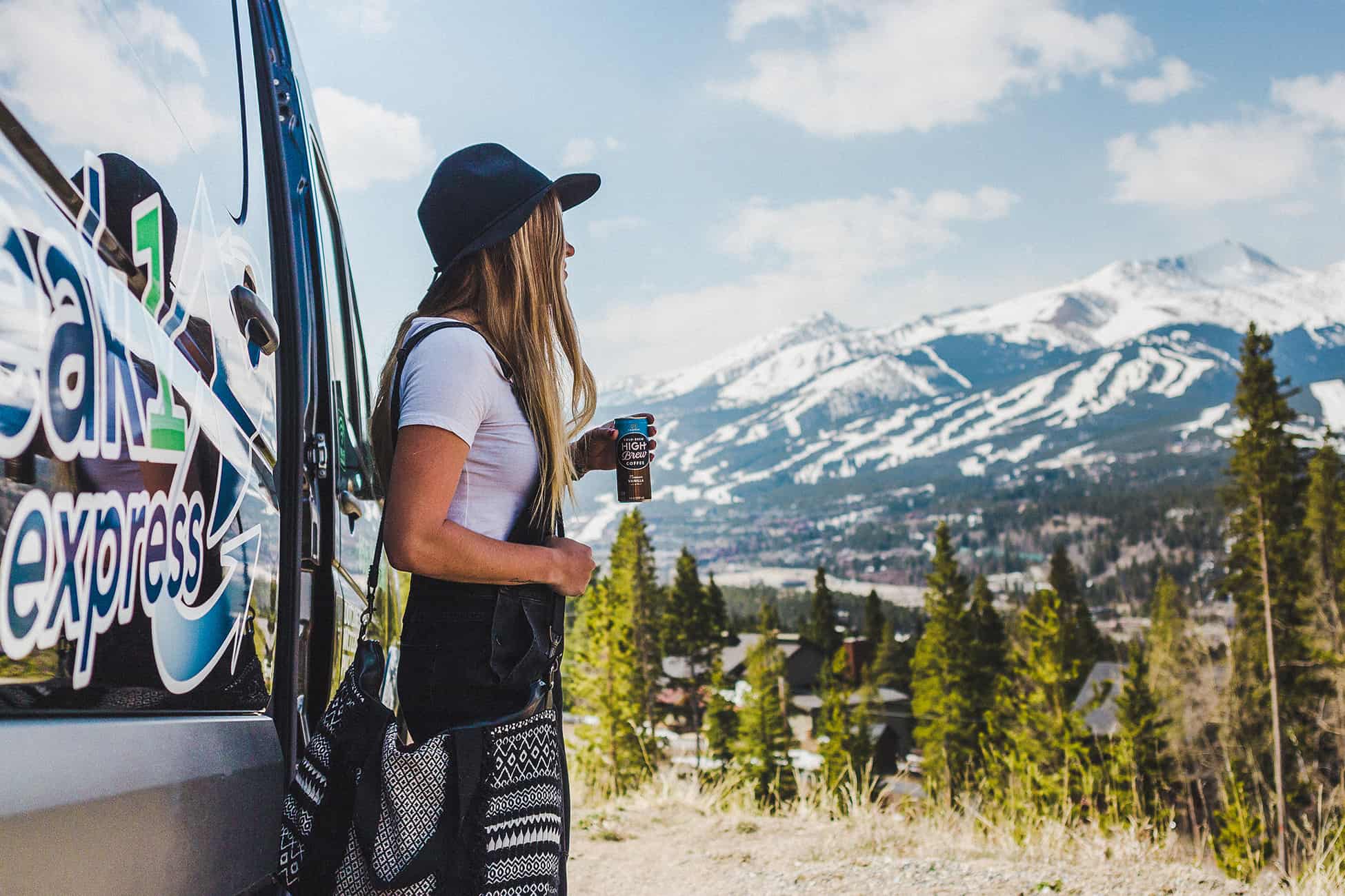 Woman holding coffee in the Colorado mountains