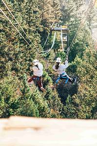 two girls ziplining