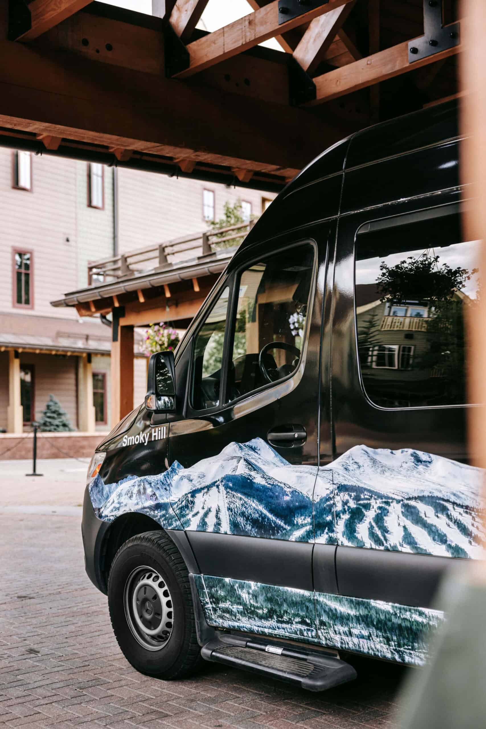 Mountain shuttle parked at a hotel in the mountains