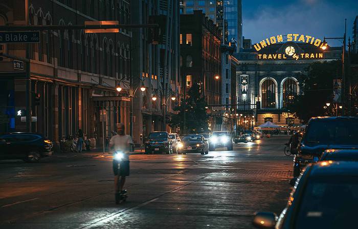 man scootering in front of union station