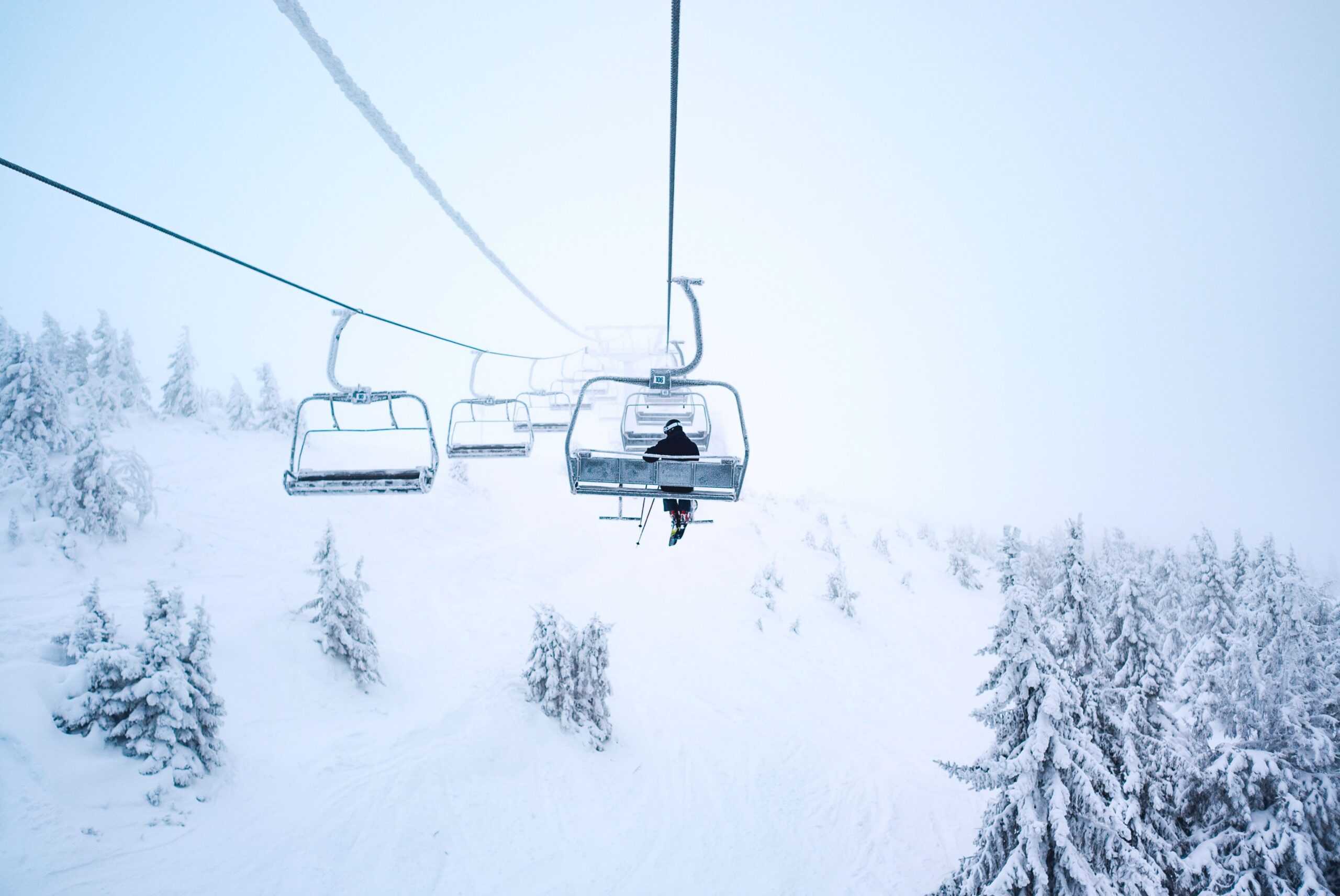 person riding ski lift at resort.