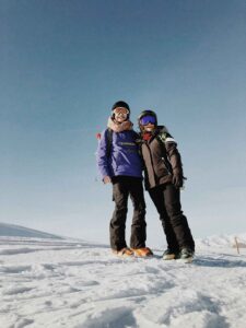 couple standing on top of ski mountain