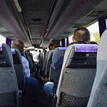 rear-view-of-passengers-on-the-bus.jpg seats in a shuttle