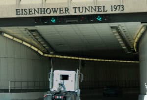 large 18 wheeler driving through eisenhower tunnel