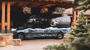 Mercedes Sprinter shuttle parked outside a hotel