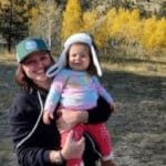 Woman holding little girl with Colorado fall backdrop