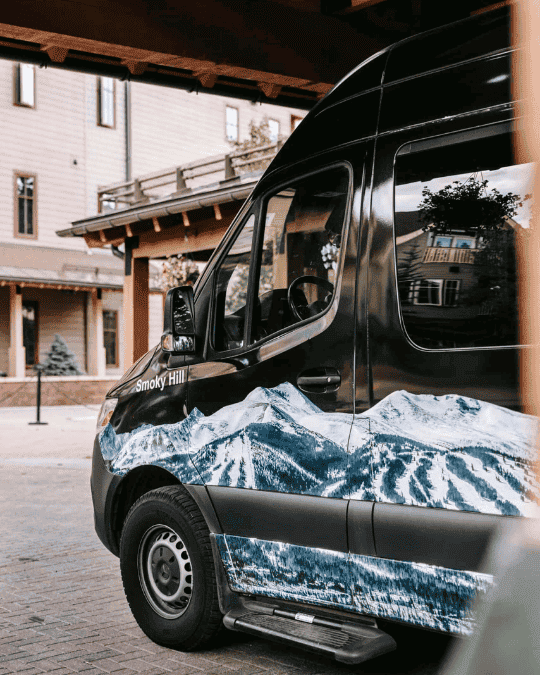 Mountain shuttle parked at a hotel in the mountains